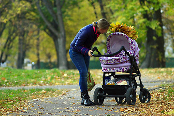 Image showing perambulator standing in the autumn park