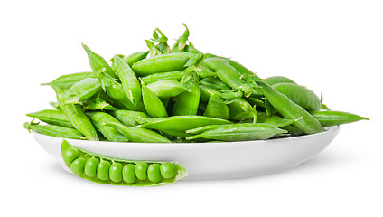 Image showing Opening and closing pea pods on white plate