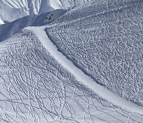 Image showing Off-piste and groomed slope with trace from ski and snowboards