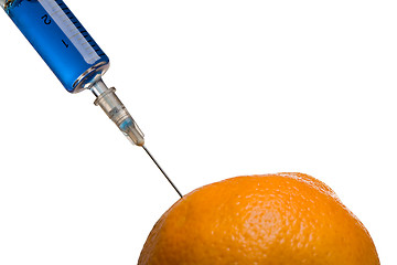 Image showing Glass syringe and orange