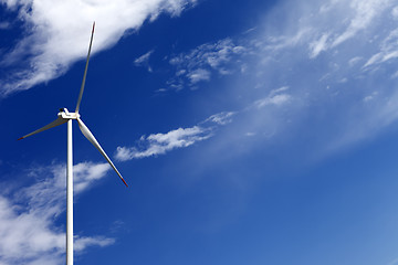 Image showing Wind turbine and blue sky with clouds