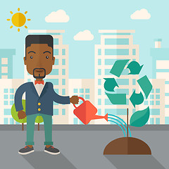 Image showing Man watering a recycling tree.