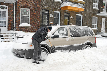 Image showing Man shovelling and removing snow