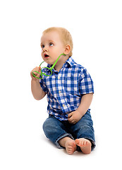 Image showing baby boy in a plaid shirt with glasses. Studio. Isolated