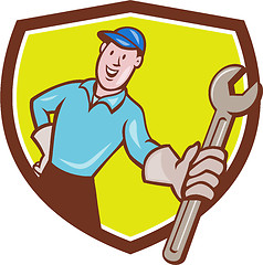 Image showing Mechanic Presenting Wrench Shield Cartoon