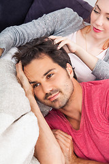 Image showing Young Couple Relaxing on Couch In the Living Room