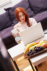 Image showing Young Woman Using Laptop In the Living Room