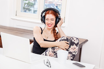 Image showing Happy Young Woman Listening Music In her Room