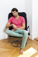 Image showing Man Sitting on Chair with Book and a Drink