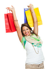 Image showing Happy Woman Raising Colored Shopping Bag