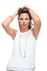 Image showing Happy Woman in Trendy Outfit Holding her Hair Up