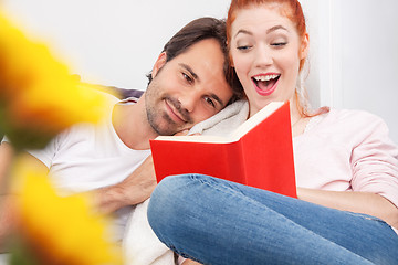 Image showing Sweet Young Couple Reading a Book Together