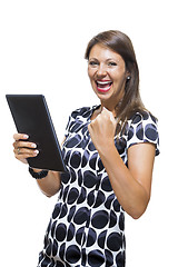 Image showing Smiling Woman in a Dress Holding a Tablet Computer