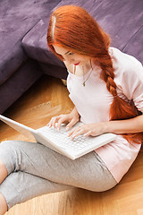 Image showing Young Woman Using Laptop In the Living Room