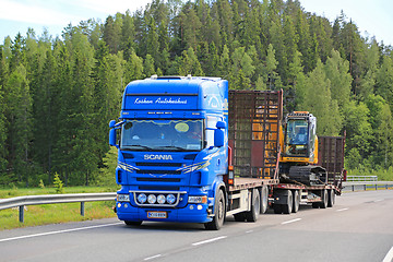 Image showing Scania V8 Truck Hauls New Holland Crawler Excavator