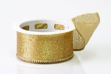 Image showing A spool of golden girft wrapping ribbon