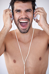 Image showing handsome young man listening music on headphones