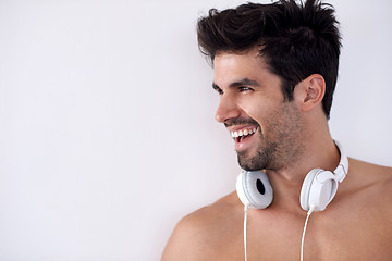 Image showing handsome young man listening music on headphones