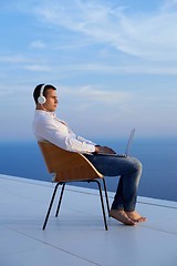 Image showing relaxed young man at home on balcony