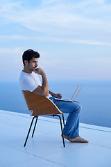 Image showing relaxed young man at home on balcony