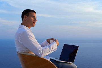 Image showing relaxed young man at home on balcony