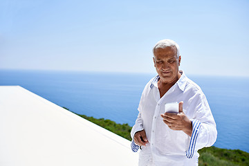 Image showing senior man using smart phone