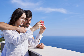 Image showing young couple taking selfie with phone