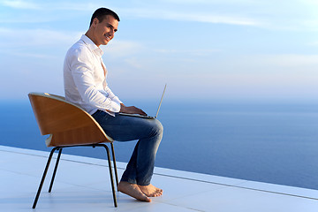 Image showing relaxed young man at home on balcony