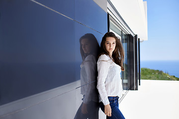 Image showing relaxed woman in front of luxury modern home