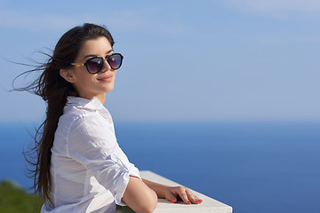 Image showing relaxed woman in front of luxury modern home