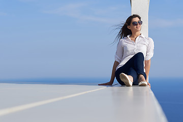 Image showing relaxed woman in front of luxury modern home