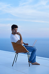 Image showing relaxed young man at home on balcony