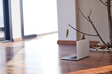 Image showing modern home indoors with laptop on floor