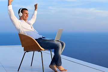 Image showing relaxed young man at home on balcony