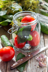 Image showing Vegetables and herbs in the glass jar for home canning.