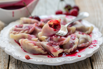 Image showing Dumplings with a cherry.