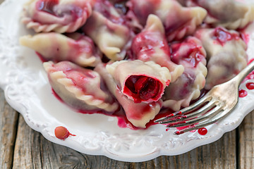 Image showing Sweet dumplings with red cherry.