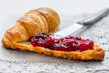 Image showing Croissant with lingonberry jam.