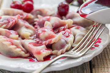 Image showing Homemade dumplings with cherries.