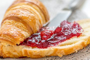 Image showing Croissant with cranberry jam closeup.