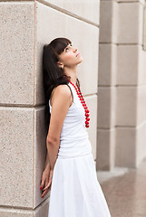 Image showing Attractive sad girl with red beads