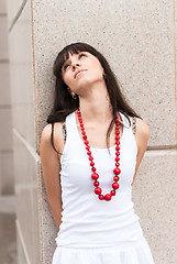 Image showing Attractive sad girl with red beads