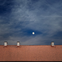Image showing tiled top of the roof, cloudy blue sky
