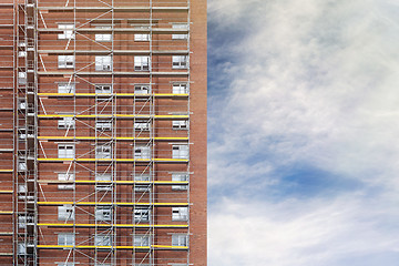 Image showing restoration facade of tall house, scaffolding construction 