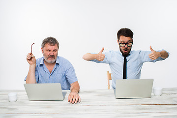 Image showing The two colleagues working together at office on white background