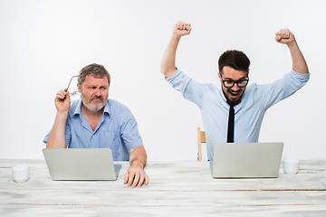 Image showing The two colleagues working together at office on white background