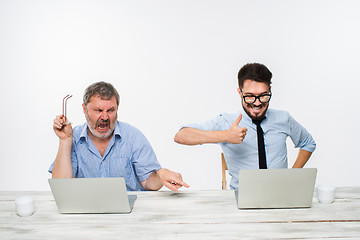 Image showing The two colleagues working together at office on white background