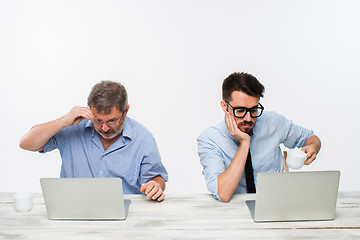 Image showing The two colleagues working together at office on white background