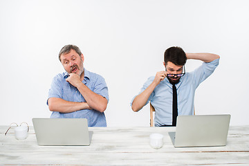 Image showing The two colleagues working together at office on white background