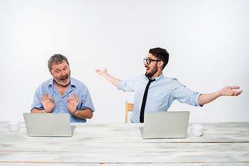 Image showing The two colleagues working together at office on white background